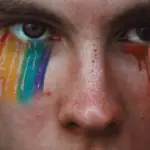 Person crying rainbow colored tears