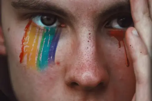 Person crying rainbow colored tears