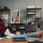 Person sitting behind a desk relaxed.